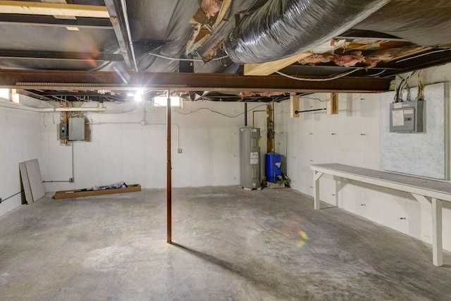 unfinished basement featuring electric panel and electric water heater