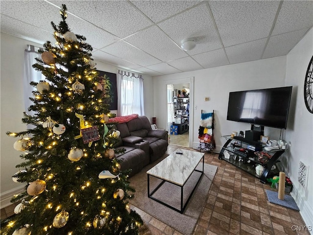 living room with a drop ceiling