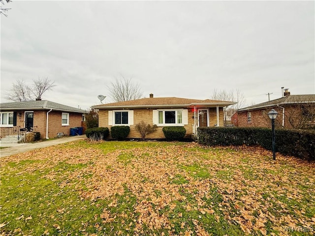 ranch-style home with a front lawn