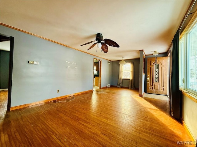 spare room with light hardwood / wood-style floors, ceiling fan, and crown molding