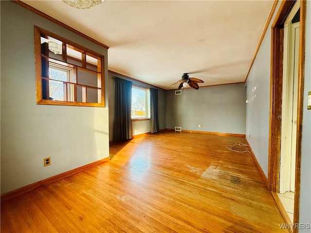 empty room with light hardwood / wood-style floors, ceiling fan, and crown molding