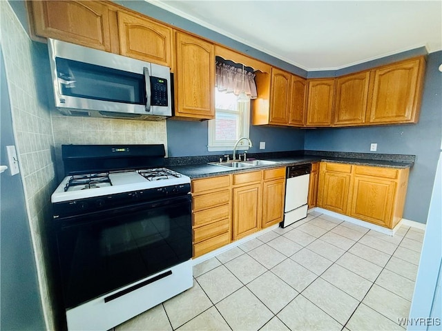 kitchen with sink, light tile patterned floors, and white appliances