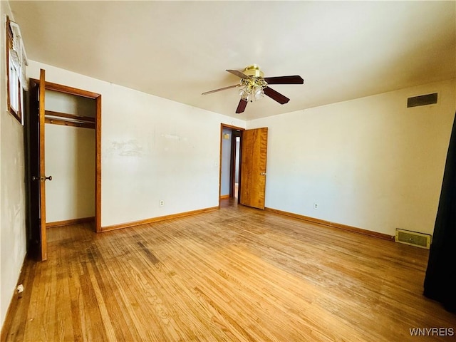 unfurnished bedroom featuring light hardwood / wood-style floors, a closet, and ceiling fan