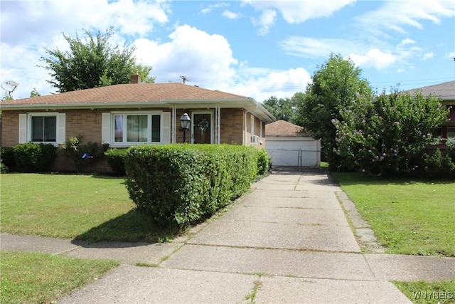 bungalow-style house with a garage, an outbuilding, and a front yard