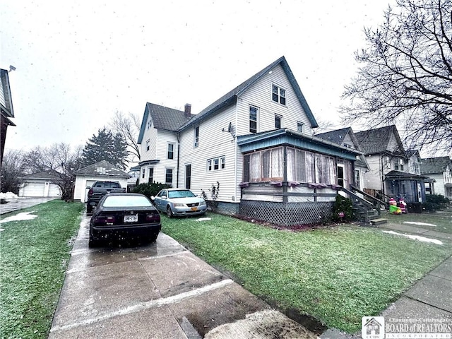 view of side of property with a lawn