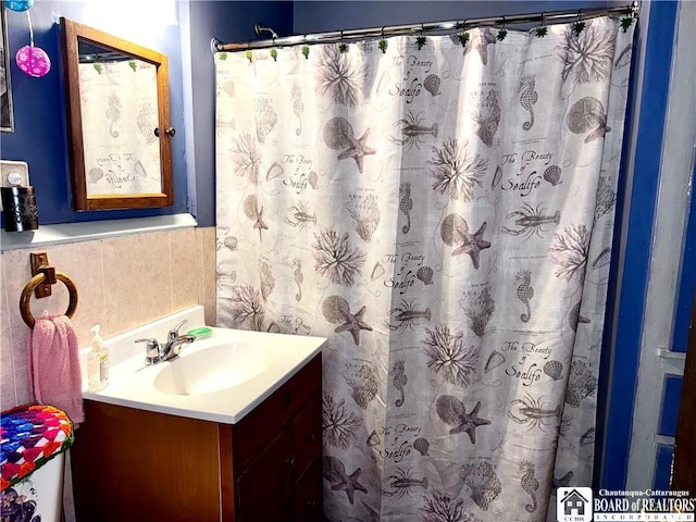 bathroom with vanity and curtained shower