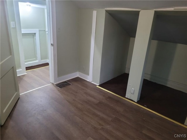 unfurnished bedroom with dark wood-type flooring