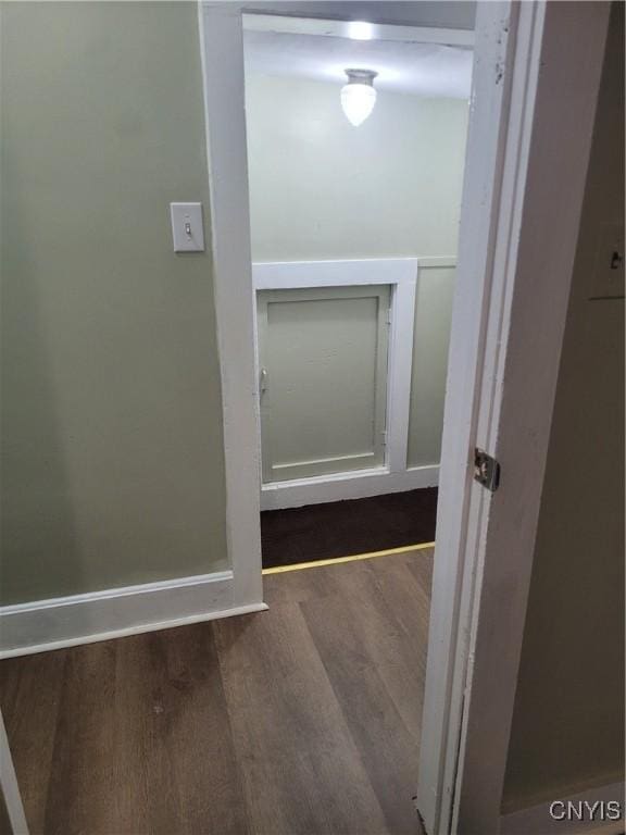 hallway with dark wood-type flooring