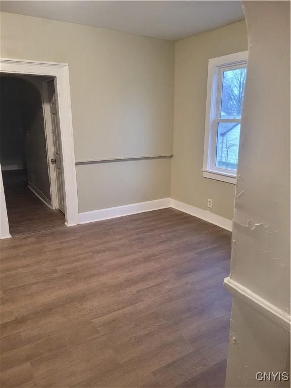 spare room with dark hardwood / wood-style floors