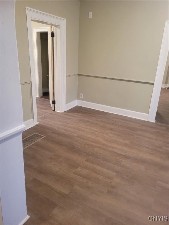 empty room featuring dark wood-type flooring