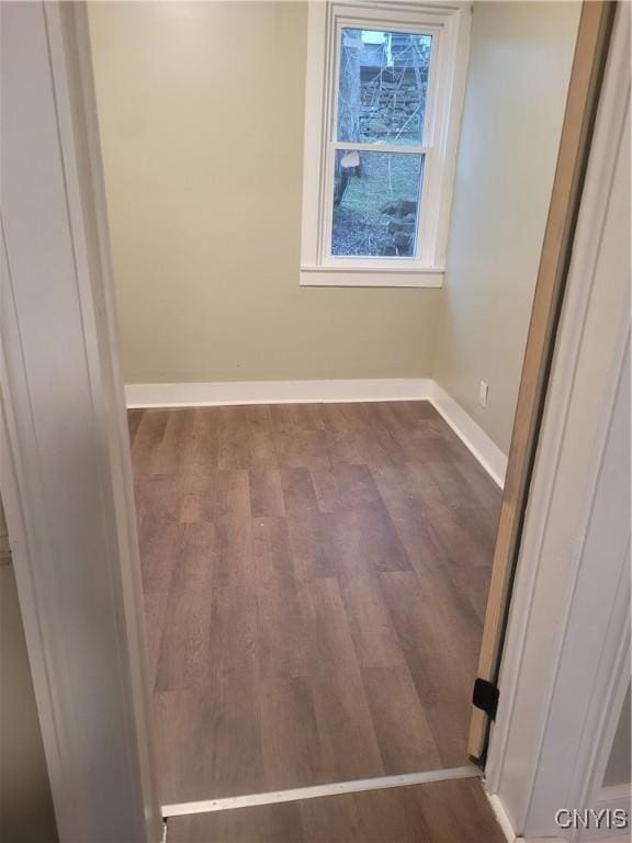 unfurnished room with dark hardwood / wood-style floors