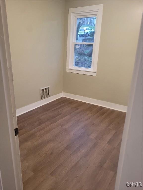 spare room with dark hardwood / wood-style flooring