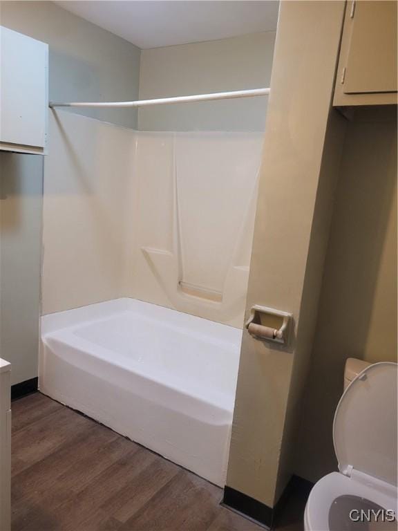 bathroom with hardwood / wood-style flooring and toilet