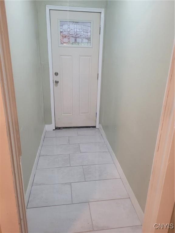 doorway with light tile patterned floors