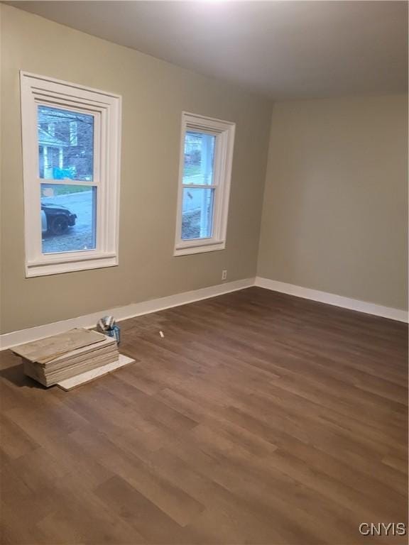 empty room with dark hardwood / wood-style floors