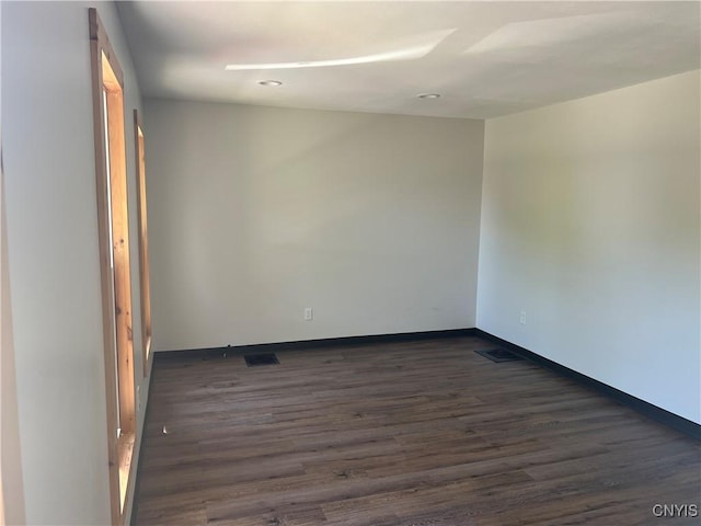 unfurnished room featuring dark wood-type flooring