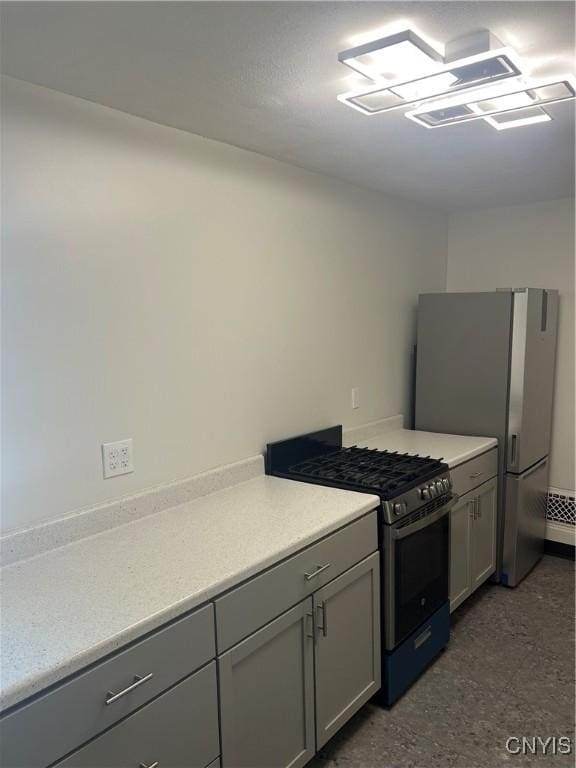 kitchen with appliances with stainless steel finishes and gray cabinets