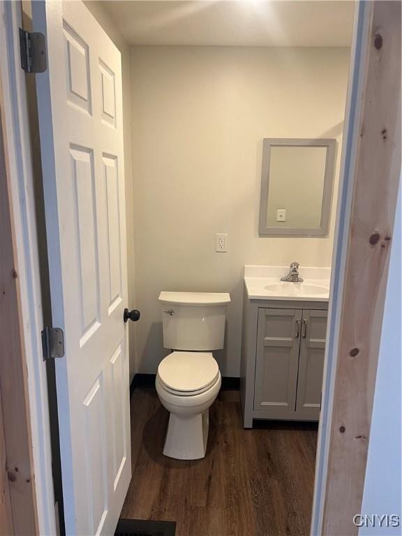 bathroom featuring hardwood / wood-style floors, vanity, and toilet