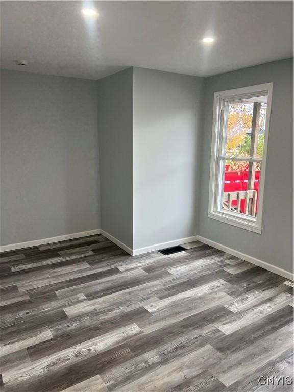 empty room with dark wood-type flooring