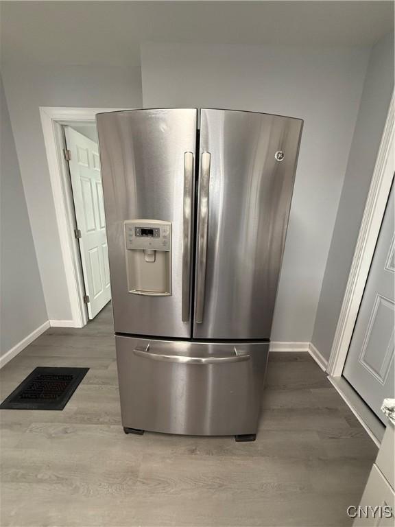 kitchen with stainless steel fridge and light wood-type flooring