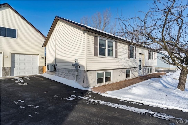 view of snow covered exterior with ac unit