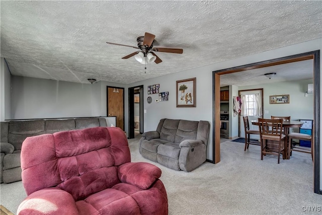 living room featuring ceiling fan and a textured ceiling