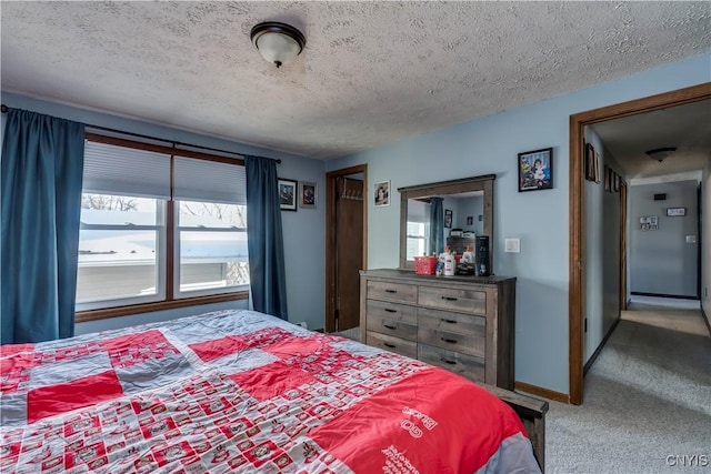 bedroom with carpet floors and a textured ceiling