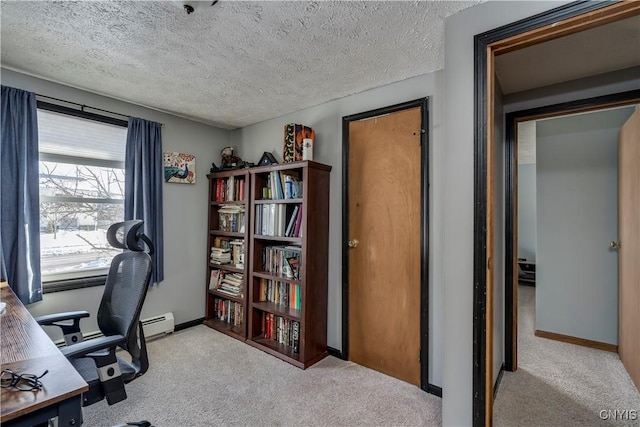 office space featuring light colored carpet, baseboard heating, and a textured ceiling