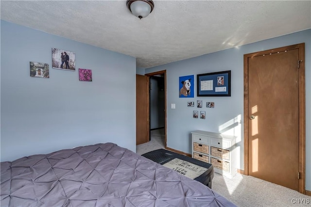 carpeted bedroom featuring a textured ceiling