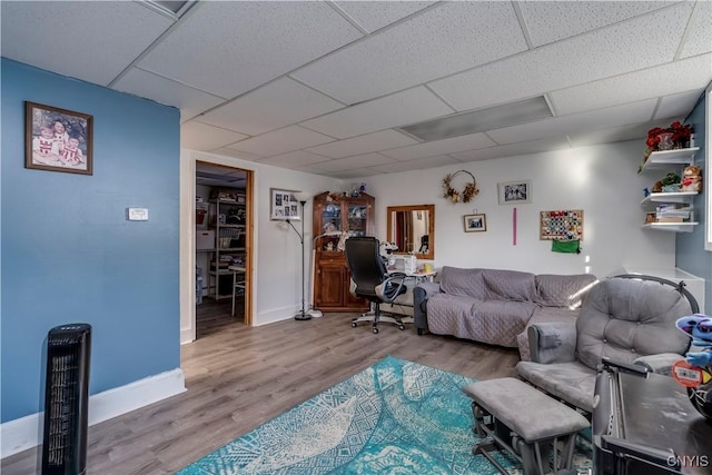 living room with a paneled ceiling and hardwood / wood-style flooring