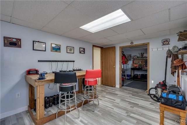 office space featuring light hardwood / wood-style floors and a drop ceiling