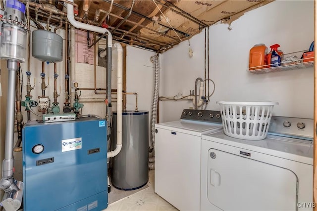 washroom with washing machine and dryer and water heater