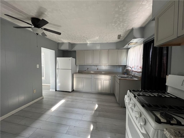 kitchen featuring ceiling fan, sink, and white appliances