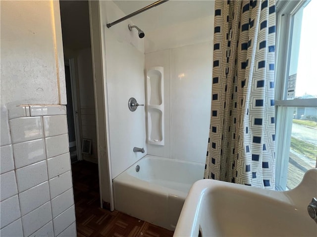 bathroom with parquet floors and  shower combination