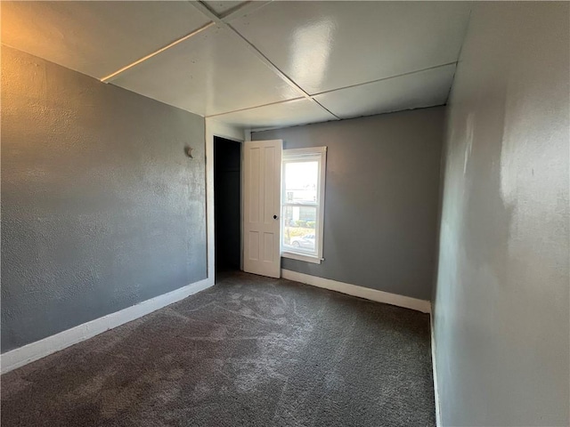 empty room featuring dark colored carpet