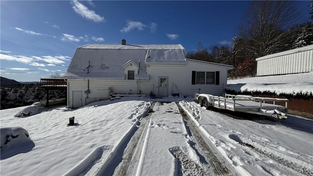 view of snow covered rear of property