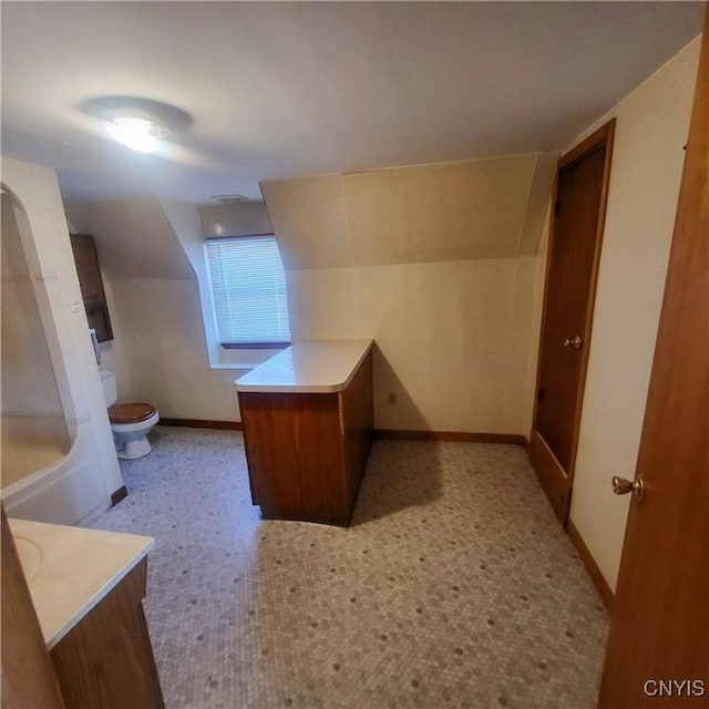 bathroom featuring toilet, vanity, baseboards, and tile patterned floors