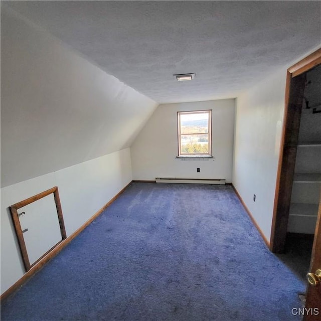 additional living space with lofted ceiling, carpet, a baseboard radiator, and baseboards