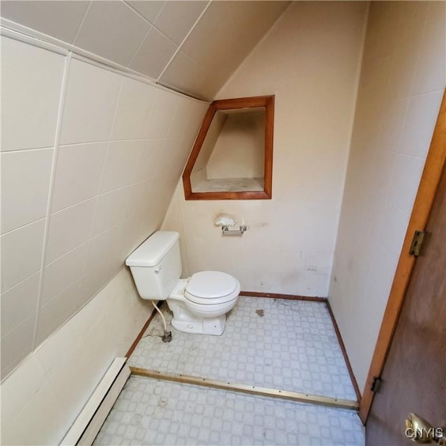 bathroom with toilet, a baseboard radiator, vaulted ceiling, and tile patterned floors