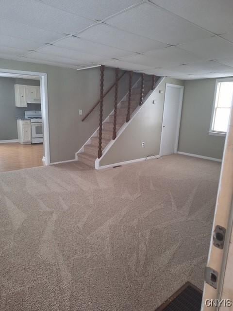 basement featuring carpet and a drop ceiling