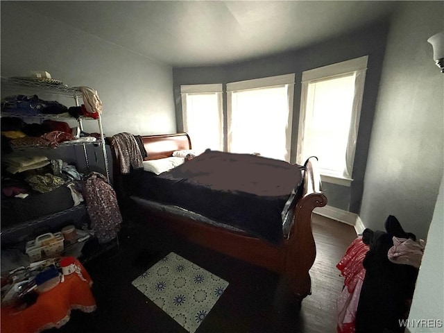 bedroom with dark wood-type flooring