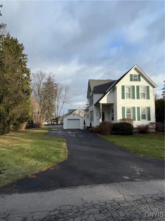 view of side of home with a yard and a garage