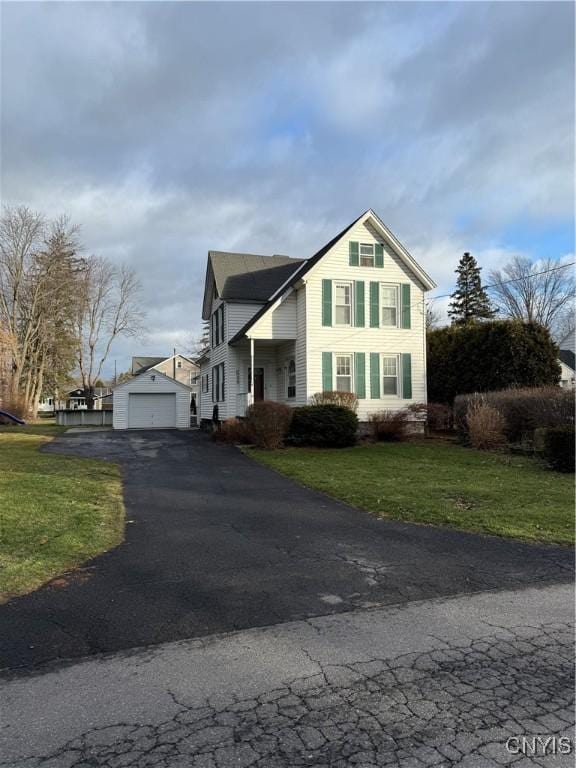 view of front property featuring a garage and a front yard