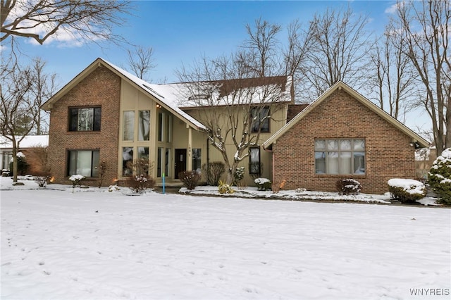 view of snow covered rear of property