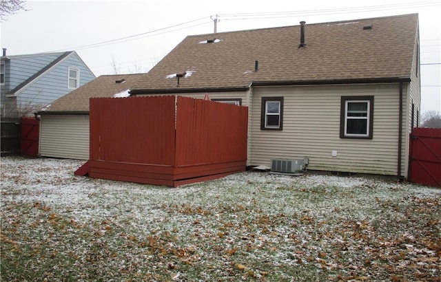 rear view of property with central AC unit