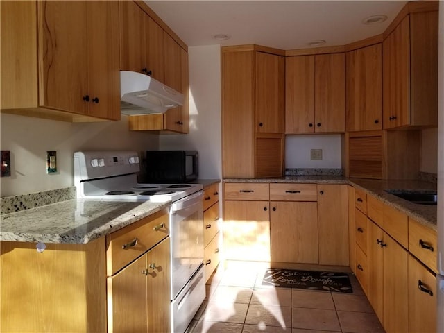 kitchen with light stone countertops, electric range oven, and light tile patterned flooring