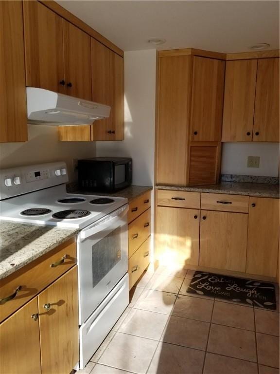 kitchen with white range with electric cooktop, light stone countertops, and light tile patterned floors