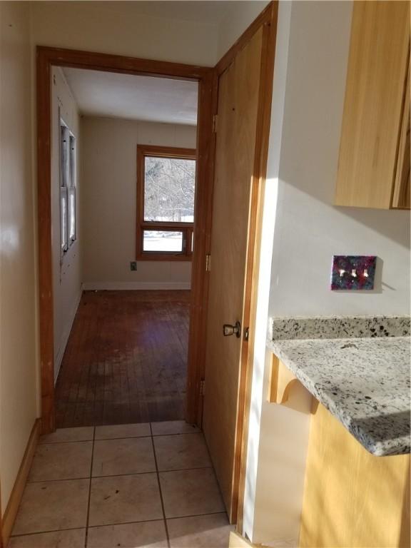 corridor with light tile patterned floors