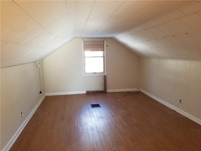 bonus room with dark hardwood / wood-style flooring and lofted ceiling