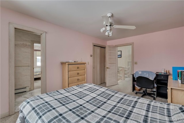 bedroom featuring ensuite bath, ceiling fan, and a baseboard heating unit